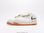 White sports shoes with black detail accents and a brown sole